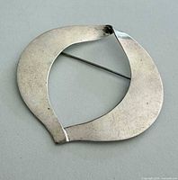Rear view of brooch showing overall shape and clasp
