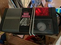 Top view of Bon-Aire inflator showing vented housing, Max Power label, red light lens, and carry strap