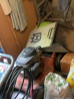 Top view showing Honda engine on Husqvarna deck with coiled cable and bag nearby