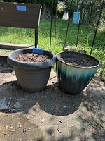 Overall view of both plastic planter pots outdoors