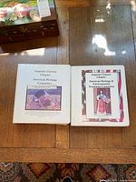 Two white binders side by side on table showing cover inserts