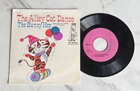 Front of picture sleeve and vinyl record showing artwork and pink label