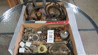Both cartons showing assorted antique lamp parts and hardware