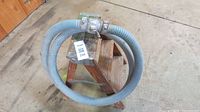 Coiled corrugated hose on small step stool