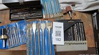 Variety of drill accessories on workbench
