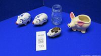 All five pig items with glass jar overview