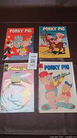 Group shot of all four Porky Pig comic books laid out