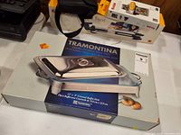Front of retail box showing Tramontina covered chafing dish image and size