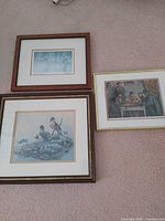 All three framed prints arranged on carpet