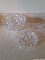 Group shot showing all three ABP cut crystal pieces: bowl, elongated dish, shallow dish