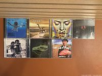 All seven CD jewel cases laid out on table