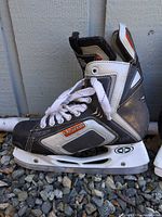 Left side view of single Easton hockey skate showing color, design and holder