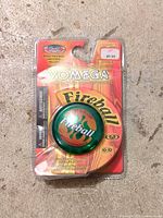 Front view of sealed Yomega Fireball yo-yo package showing green yo-yo and branding