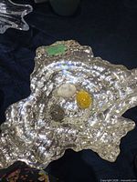 top view of silvered glass bowl with three decorative eggs