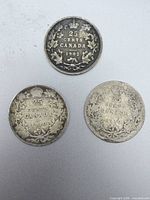 Reverse sides showing 1902 and two 1910 wreath design