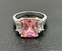 Front view showing pink center stone and two clear side stones