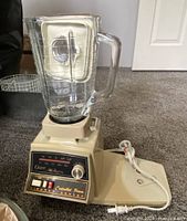 Motorized base with glass blender jar attached