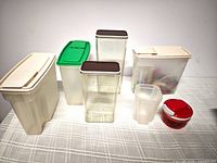 All seven plastic kitchen pieces arranged on table