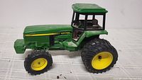 Left side view showing full tractor, dual rear wheels, paint condition