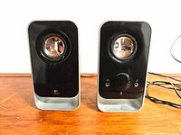 Front view of both speakers showing drivers and design