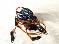 Pile of multicolored braided bungee cords showing hooks