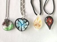 Group shot showing all four pendant necklaces in lot