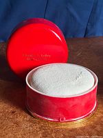 Tin with lid off showing mesh applicator