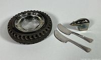 Group shot showing tyre ashtray, two Torun cheese knives and silver-plated polar bear paperweight