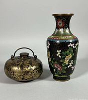 Hot-water bottle and vase side by side full view