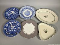 Six assorted plates and serving dishes laid out