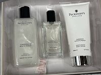 Open box showing all three Pecksniff's products in molded tray