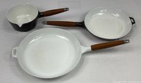 Top view of all three Copco enamel cookware pieces showing size and color differences