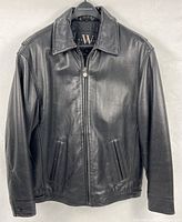 Front view of black leather jacket on hanger