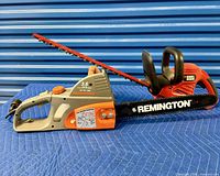 Remington chainsaw and Black & Decker hedge trimmer side by side