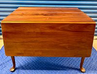 Full view of table with leaves down showing cabriole legs and finish
