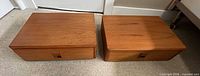 pair of teak veneer nightstands front view