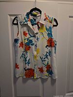 Front view of Cleo floral sleeveless blouse with tags