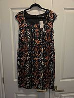 Front view of Cleo Petites abstract print sheath dress on hanger