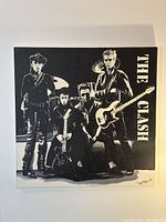 Full view of black and white Clash painting on wall