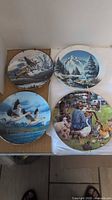 Group shot of all four plates showing artwork and condition