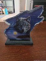 Front view showing wolf artwork, moon, and overall shape