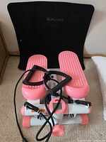 Front view of KitGody mini stepper with resistance bands and black mat