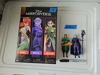 Front of retail box beside Mulan and Belle figures loose with accessories