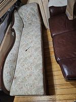 Top view of full fainting couch showing serpentine back and floral upholstery
