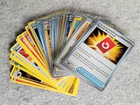 Fan spread of sleeved Pokémon cards showing variety
