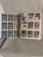 Binder open showing card backs and Boston Bruins cards