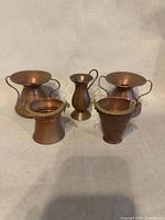 Front view of all five copper pieces