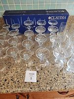 Full set of crystal stemware on countertop with Claudia box visible