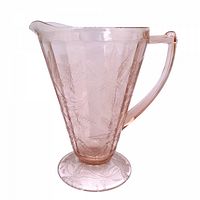 Left front view of pink depression glass footed pitcher