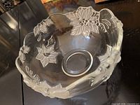 Clear glass serving bowl with raised floral motif